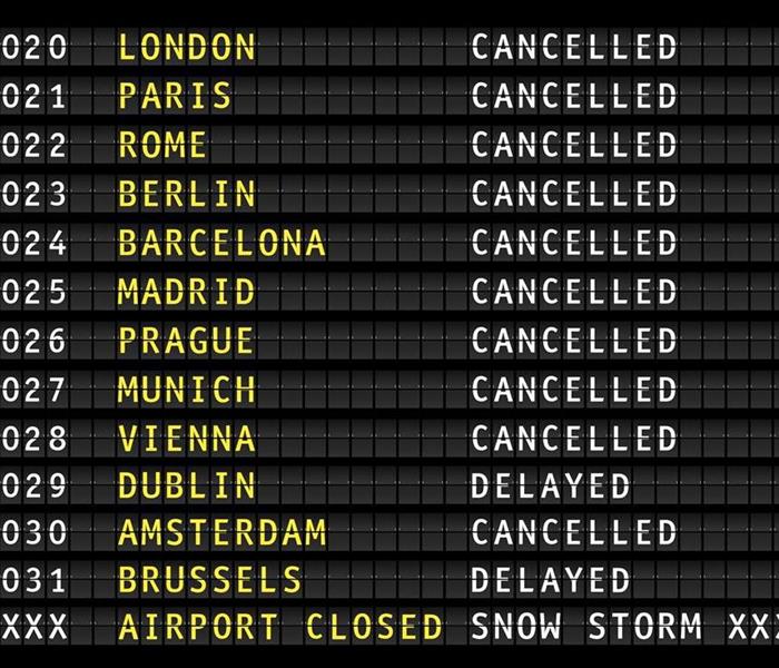 Flight information on an airport showing cancelled flights because of a thunderstorm